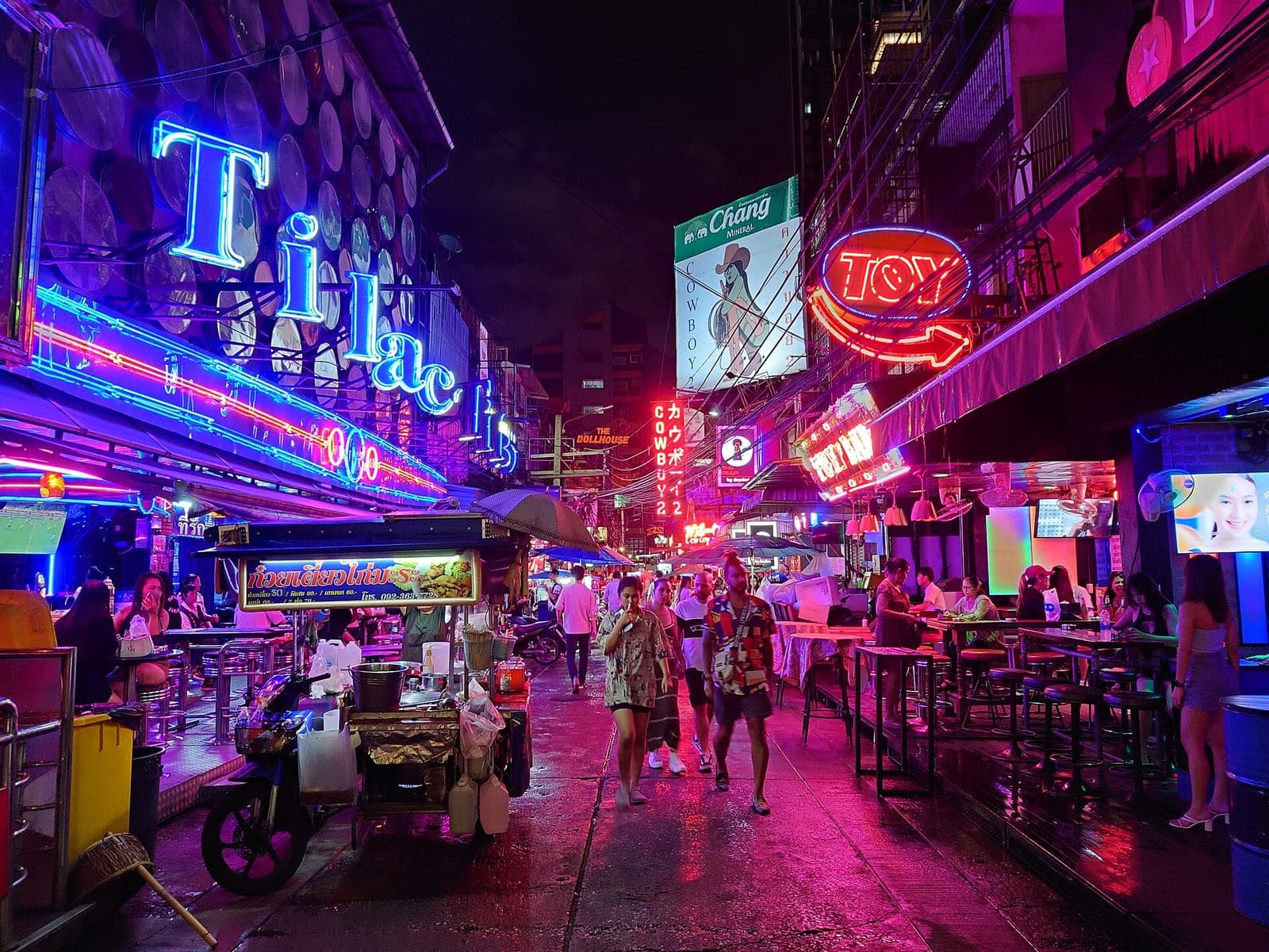 Neon signs of Tilac and other bars on Soi Cowboy, Bangkok, at night