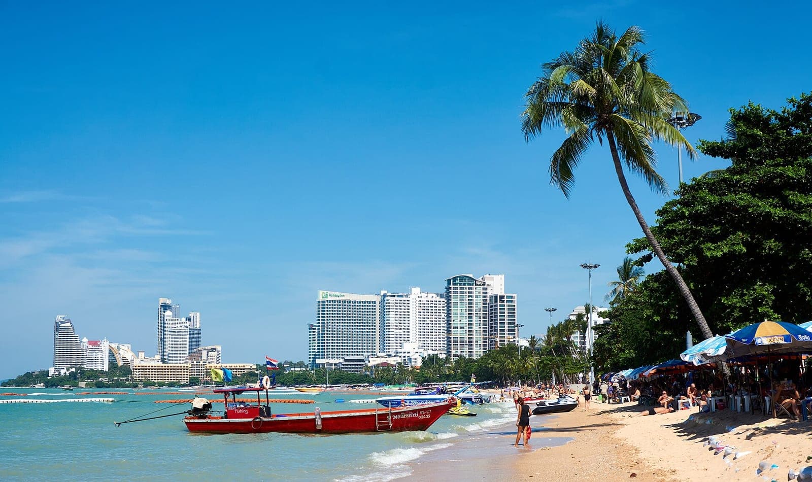 Pattaya Beach on a sunny day with deckchairs and umbrellas