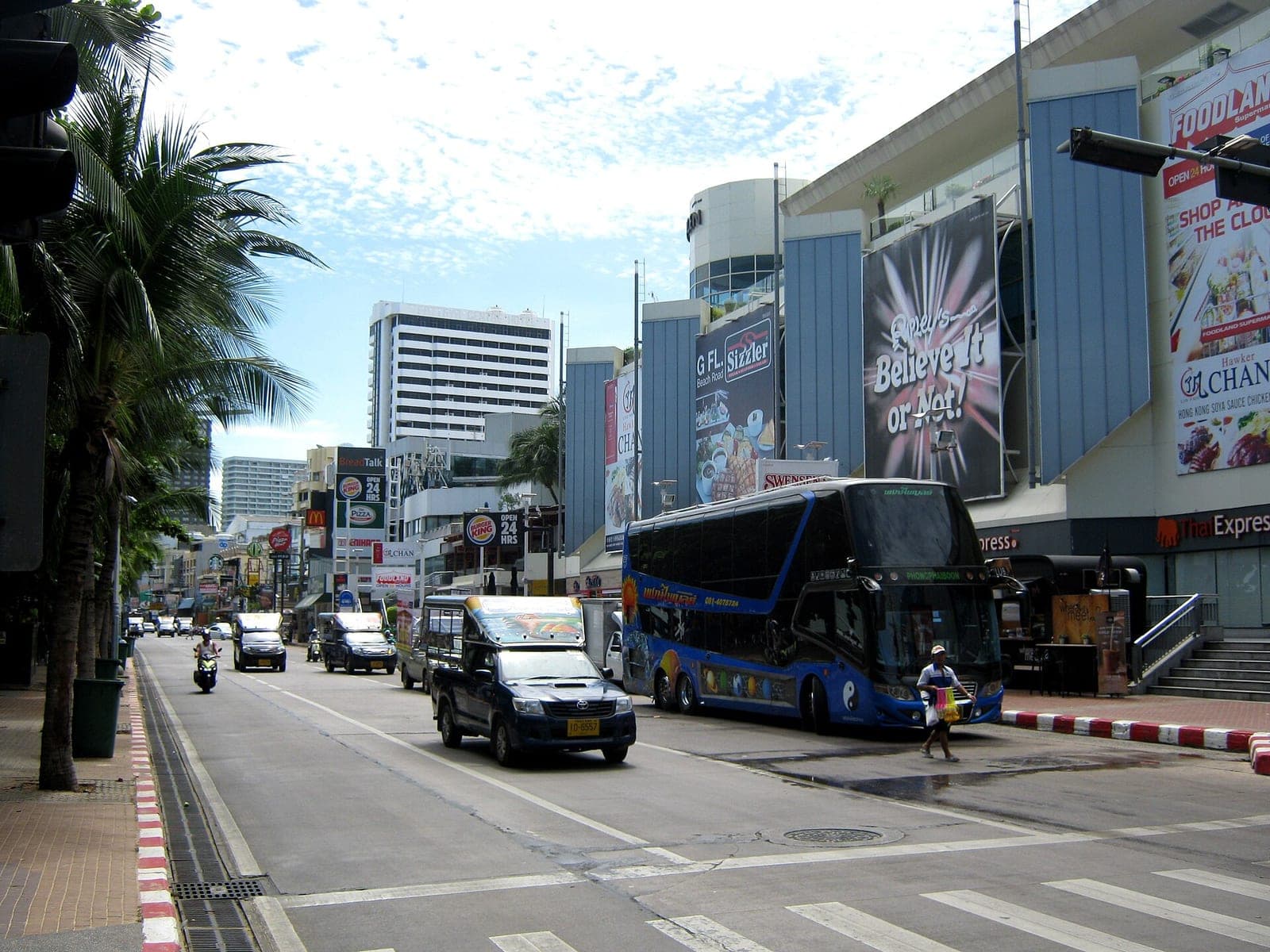 Beach Road, Pattaya, in daytime with baht buses, a tour coach and the Central Festival mall