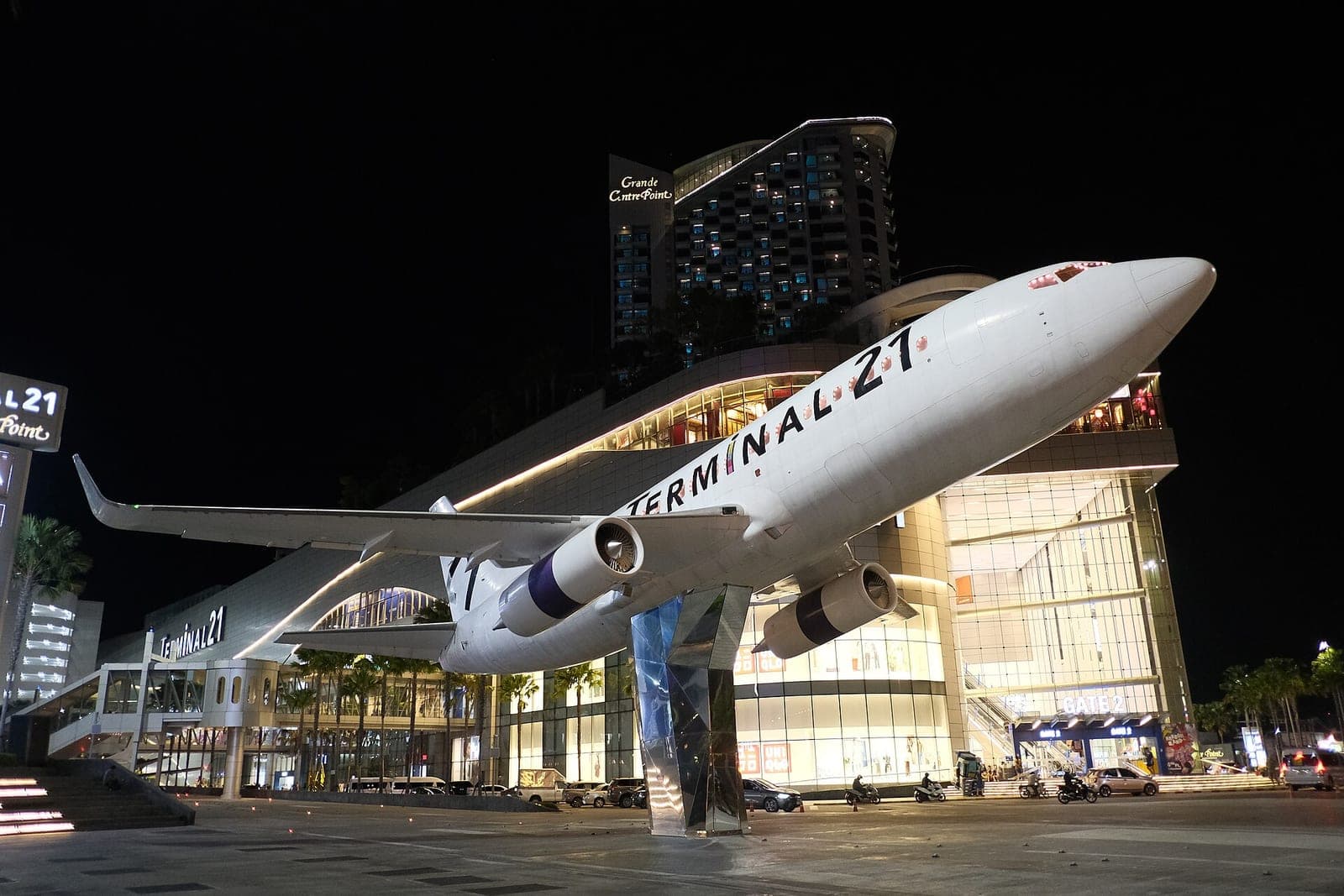 Terminal 21 Pattaya shopping mall at night with its full-size aircraft model at the entrance