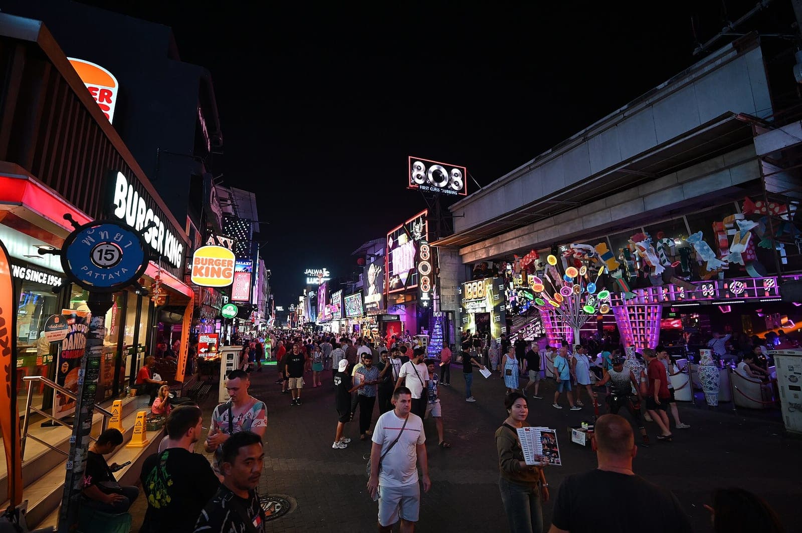 Busy Walking Street, Pattaya, at night with neon bar signs and crowds, December 2025