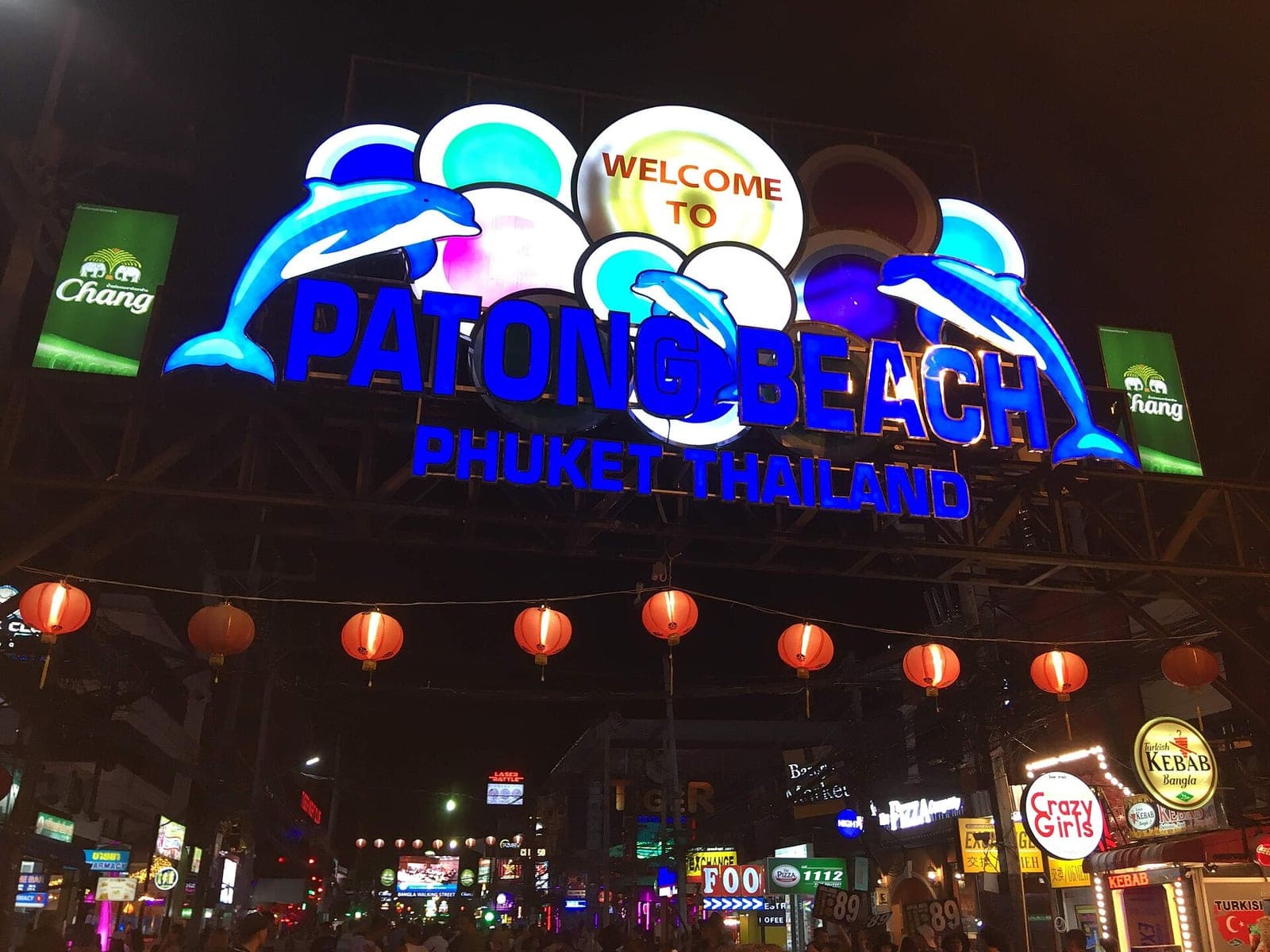 Illuminated Welcome to Patong Beach sign over Bangla Road, Phuket, at night