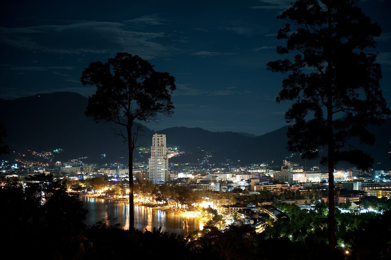 Patong Bay and the town lights at night seen from the hill above Patong, Phuket